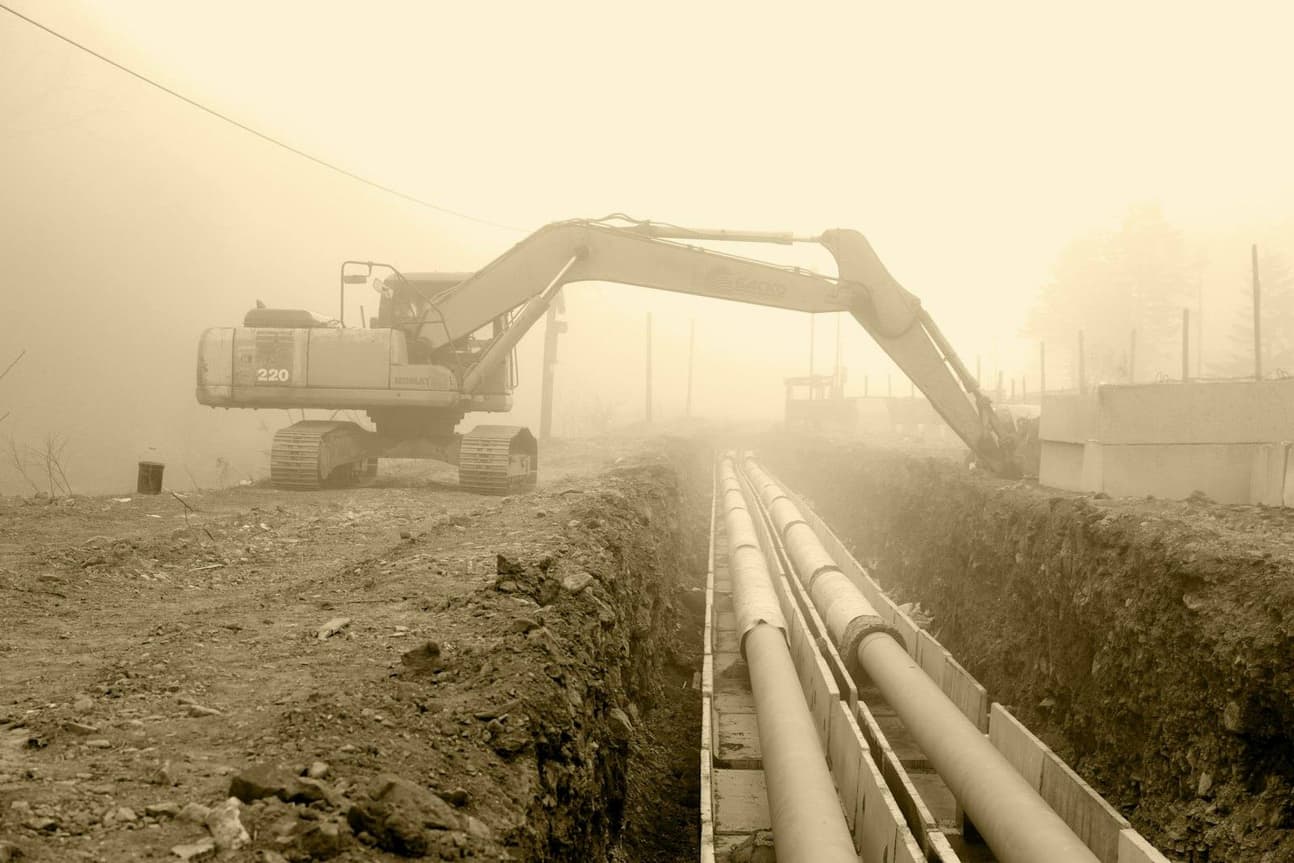 Excavator and crew working a heavy civil construction site